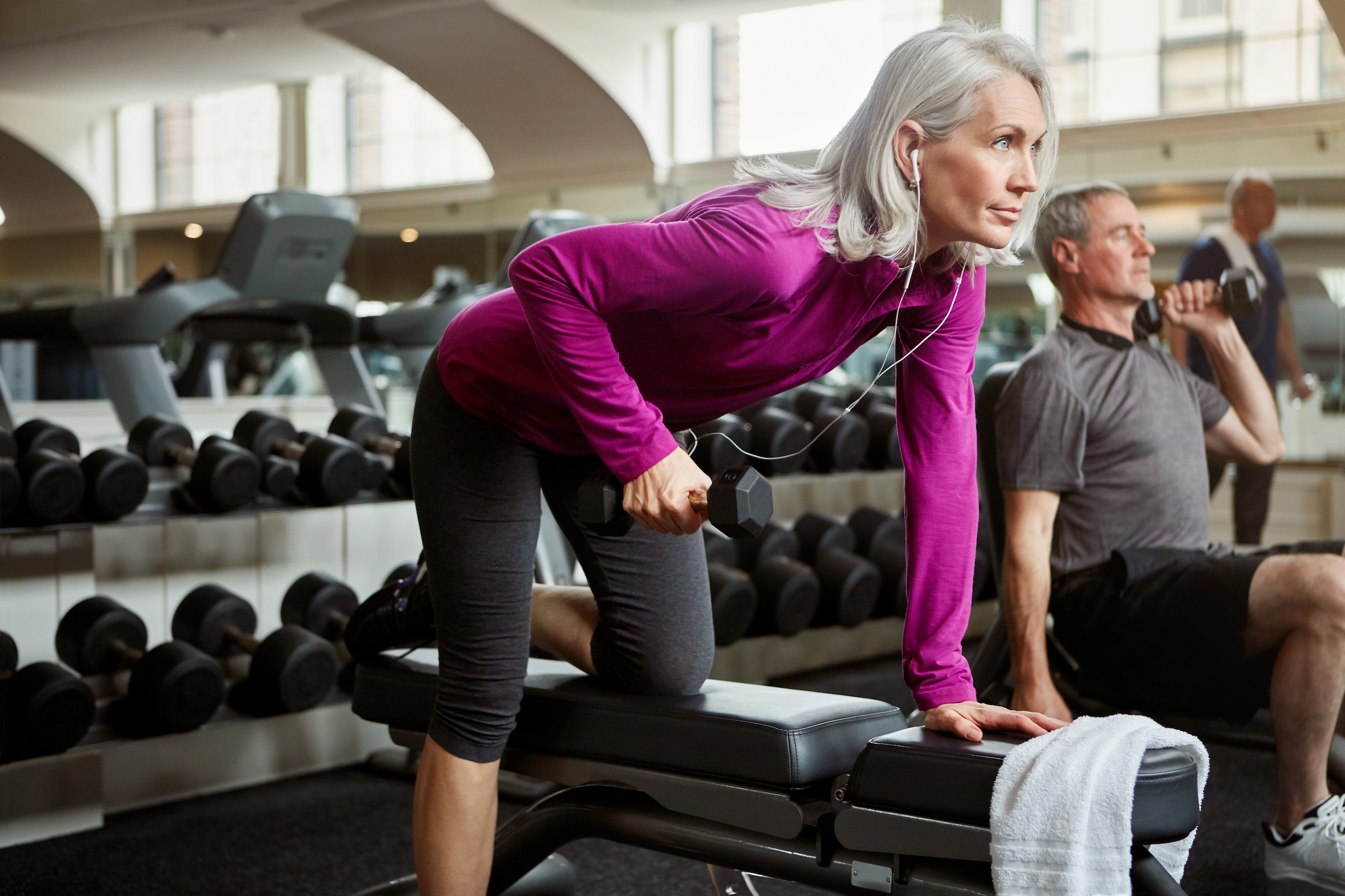 Woman lifting weights at the fitness center.
