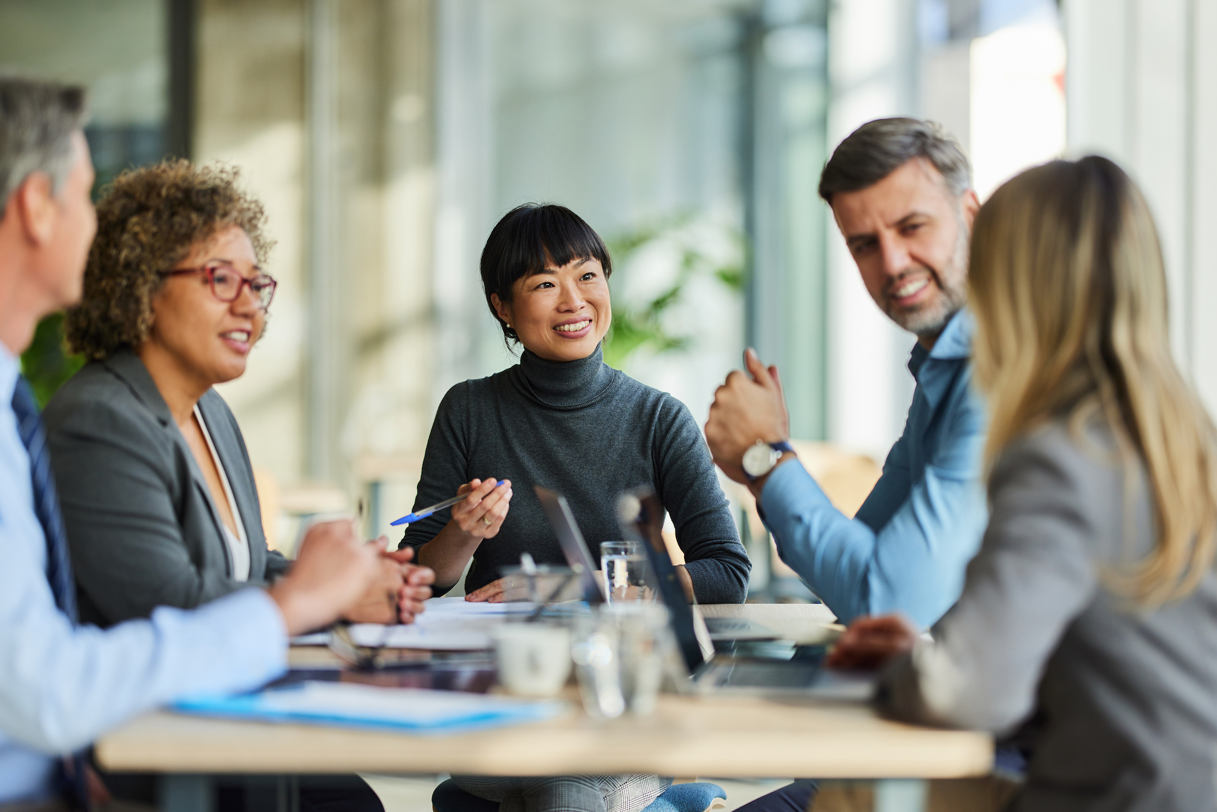 Group of people sitting at a table having a business meeting.
