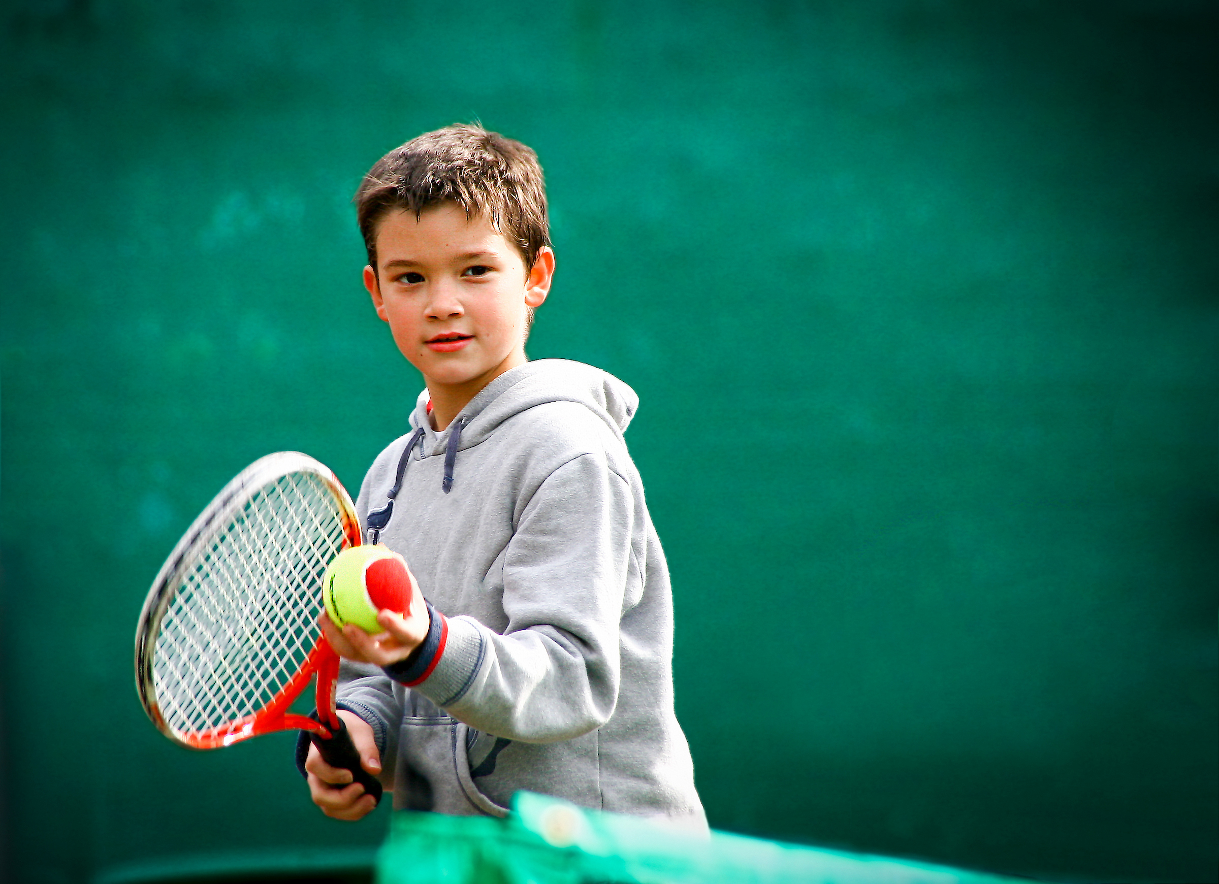 Kid with a tennis racquet.