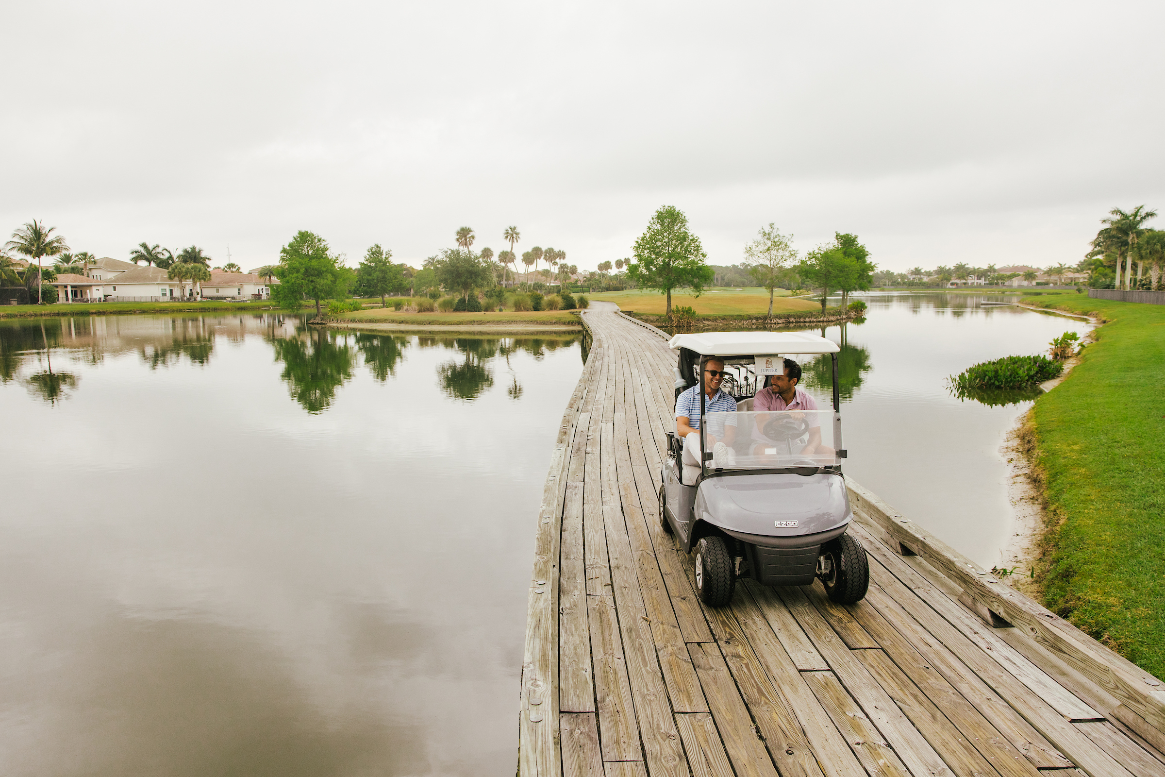 Golf cart going over boardwalk at country club in Jupiter, Florida.